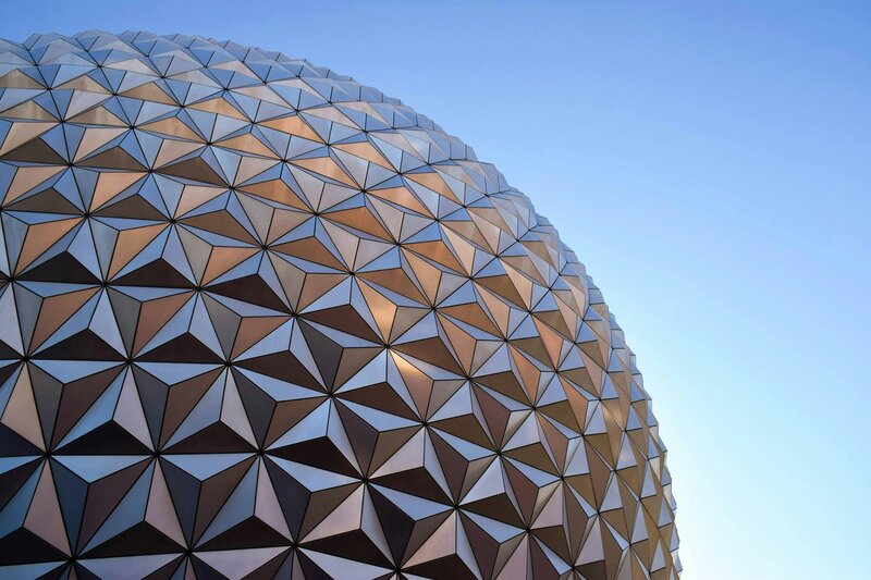 Photo couleur d'un monument moderne en forme de boule texturée devant un ciel bleu uniforme, beau contraste de texture